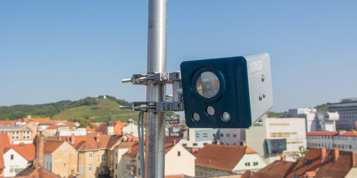KORUZA free-space optics unit on a mast above the rooftops of Maribor.